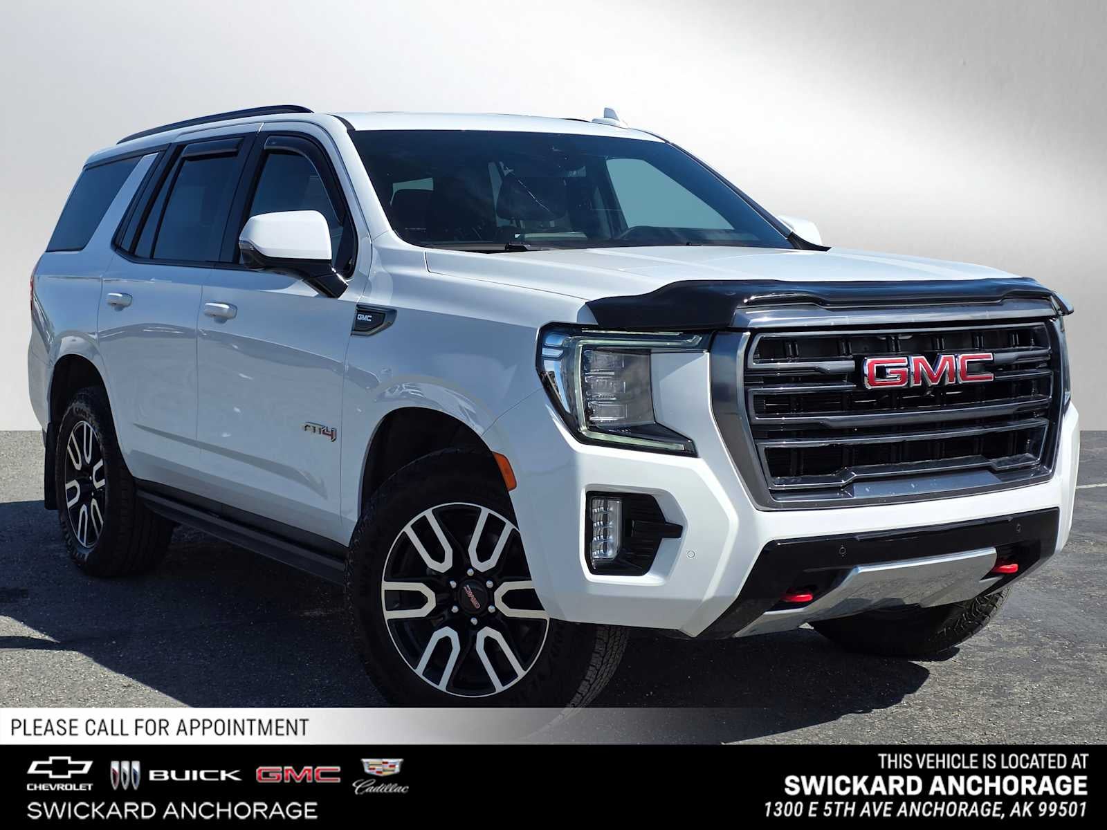 2023 GMC Yukon AT4 in Summit White — front three-quarter view