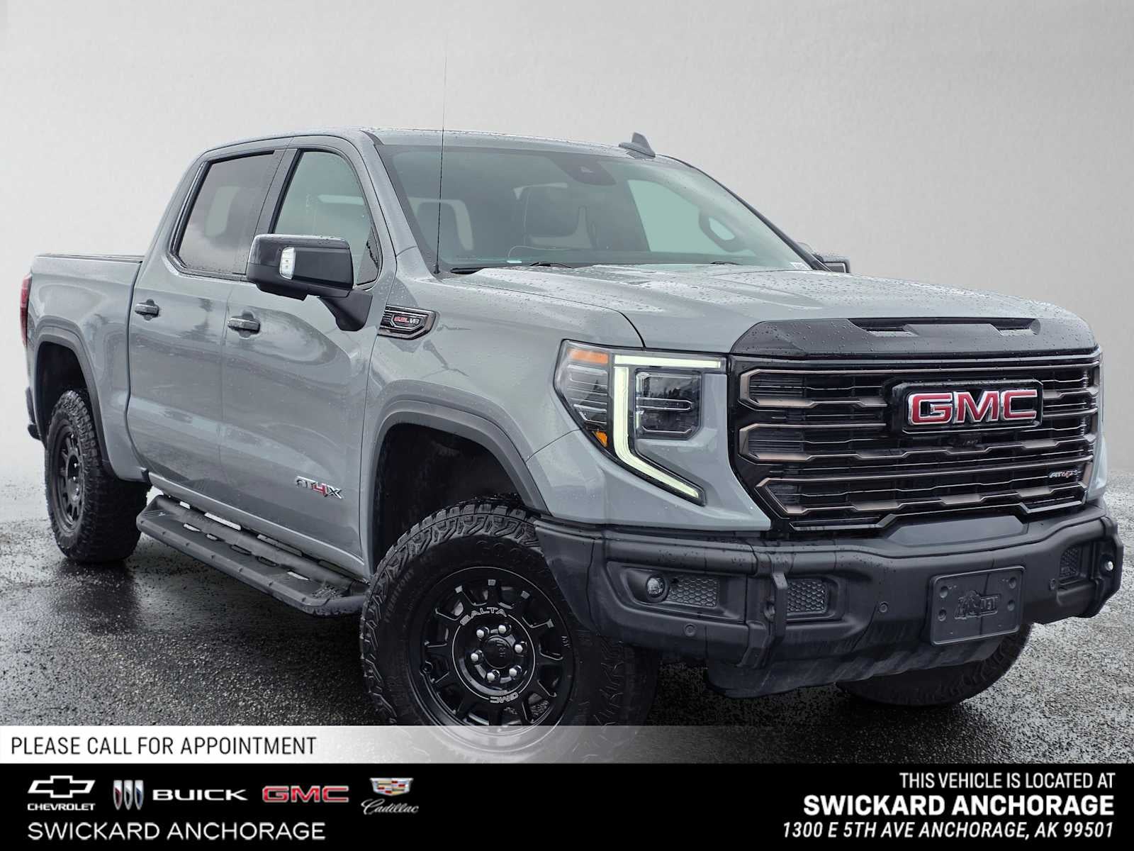 2024 GMC Sierra 1500 AT4X in Thunderstorm Gray — front three-quarter view